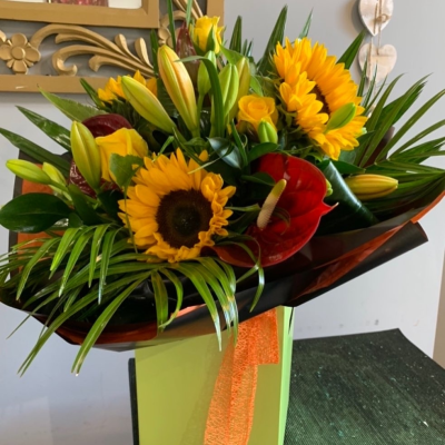 Glory Be - Like a ray of sunshine, stunning yellows and oranges and reds. The choice includes Sunflowers, yellow roses, orange lillies, red anthuriums and fabulous foliage.