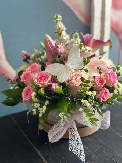 Blushing Beauty - Delight someone special with "Blushing Beauty" from Octagon Flowers, Bolton. This lovely arrangement features soft pink roses, delicate white blooms, and lush greenery, all accented with a charming green butterfly. Presented in a pretty pink and purple pot.