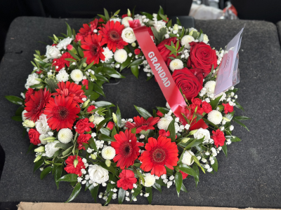 Wreath SYM-314 - This white massed wreath is finished with a red rose spray for an extra special tribute.