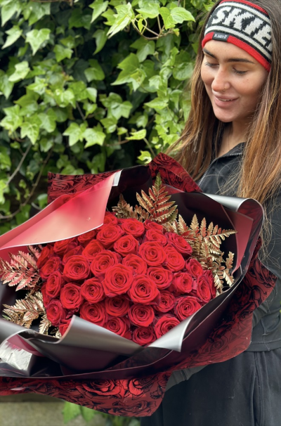 For that special someone - 50 Stunning red roses handtied with gold sprayed foliage. A stunning statement