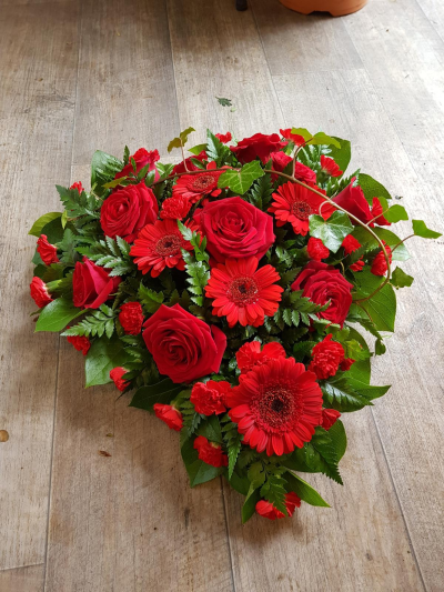 Heart wreath - Beautiful red rose, gerbera and carnations make up this heart shaped wreath