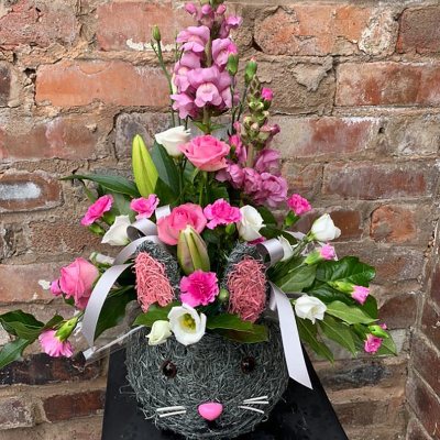 Baby girl arrangement - Front facing arrangement in mixed shades of pink in a novelty pot