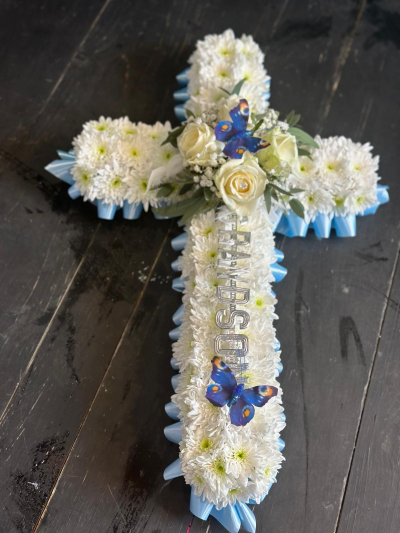 2ft Baby cross - White massed cross with ribbon edging and a matching spray in either blue or pink. With a name in silver letters