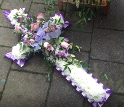 3ft Lilac Cross - 3ft lilac and white cross with lilac ribbon edging and a flower mount of lilac roses and lilac orchids with a lilac ribbon. Beautiful tribute