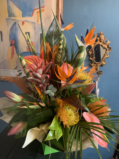 Miss Hottie - Stunning vibrant arrangement in a box. In oranges and hot pinks with lush green exotioc foliage