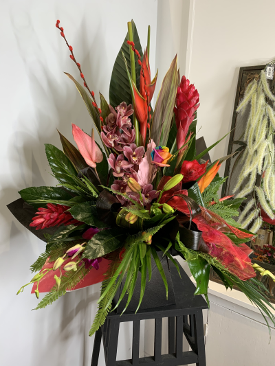 It’s a bold one - Wild and wonderful ibrant tropical arrangement to include bird of paradise, heliconia, orchids and rainbow roses (when available) with lush green foliage